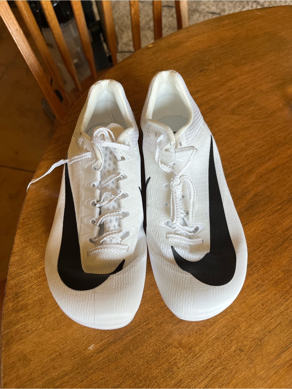 Nike White running spikes with Black Swoosh Accents